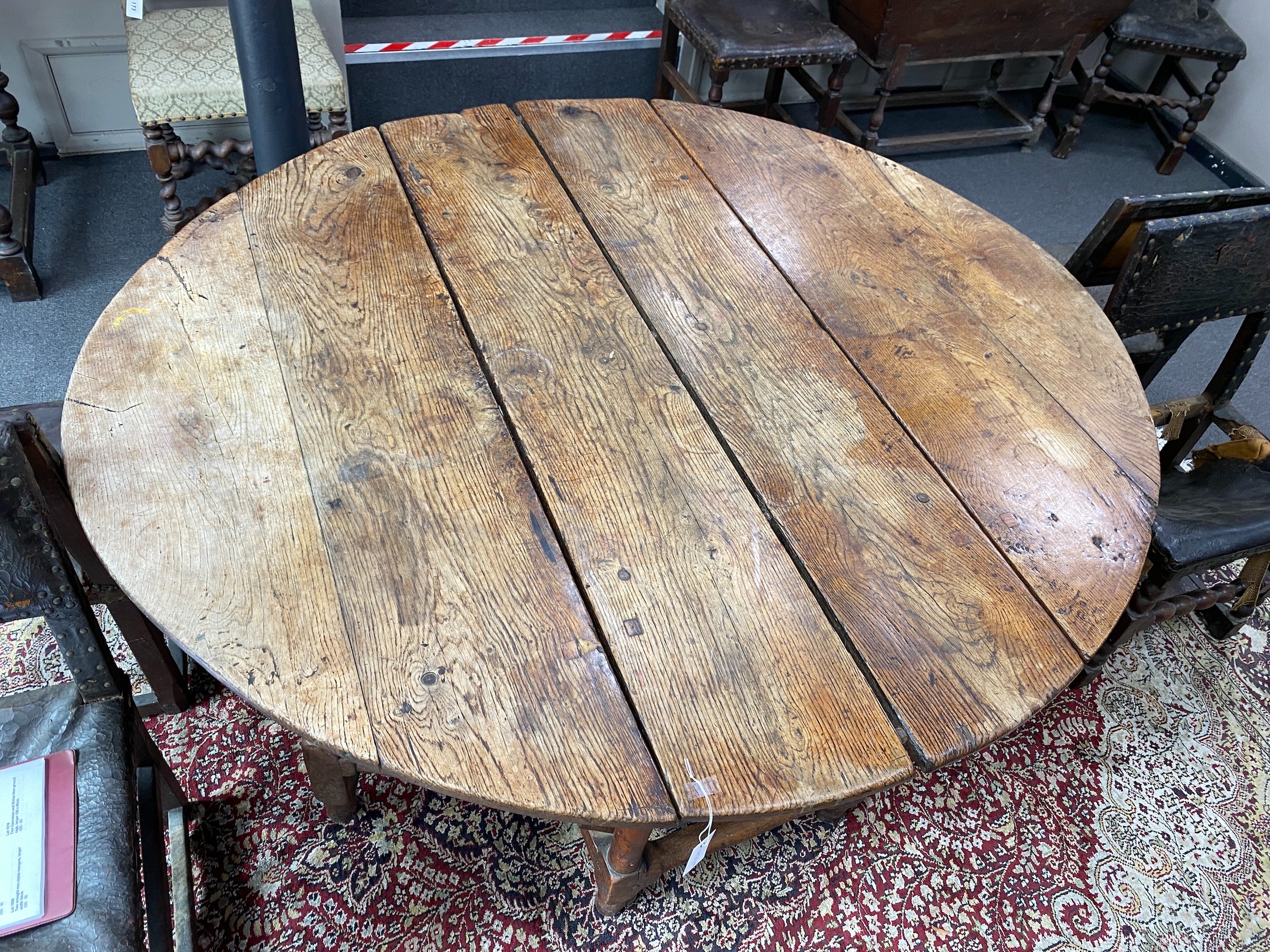A 17th century oak gateleg table, length 168cm extended, width 150cm, height 76cm